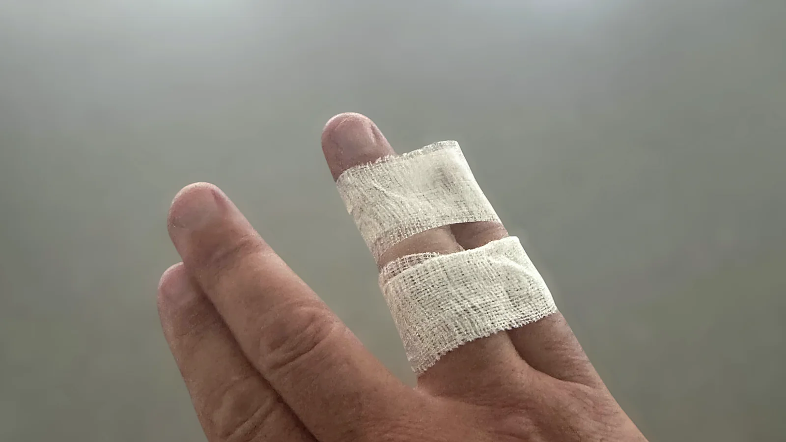 Two fingers buddy-taped with beige Guard-Tex
