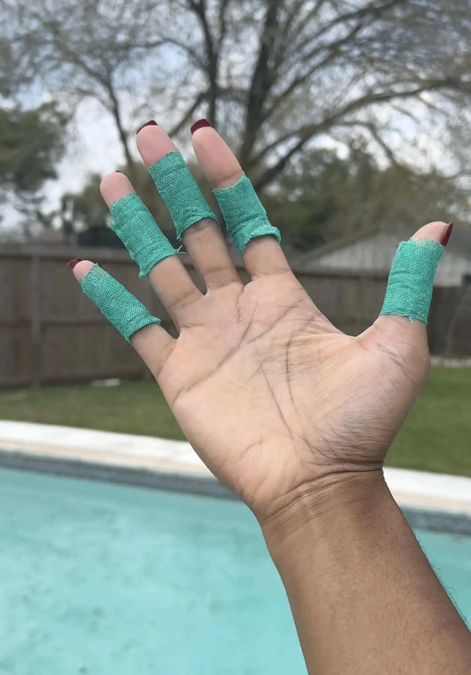 Volleyball player blocking at the net with taped fingers