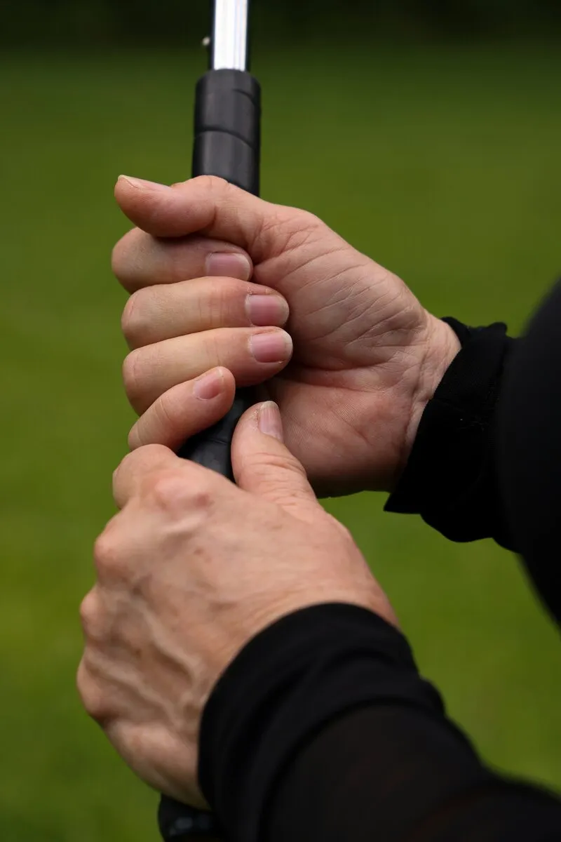 Hand gripping golf club