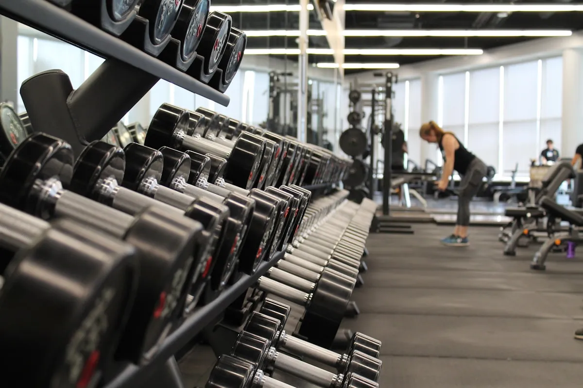 Athlete hands gripping barbell in gym