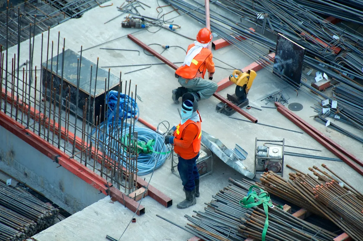 Construction worker hands with tools on job site