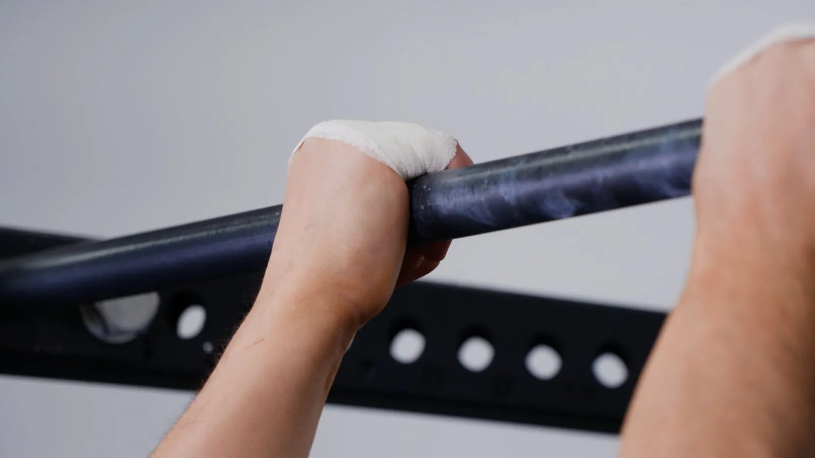 BJJ practitioner hands with Guard-Tex taped fingers gripping gi