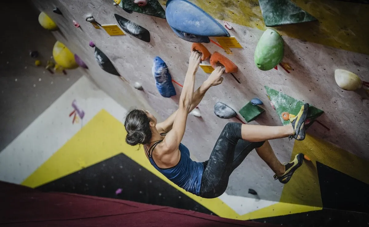 Climber pulling through an overhanging bouldering wall