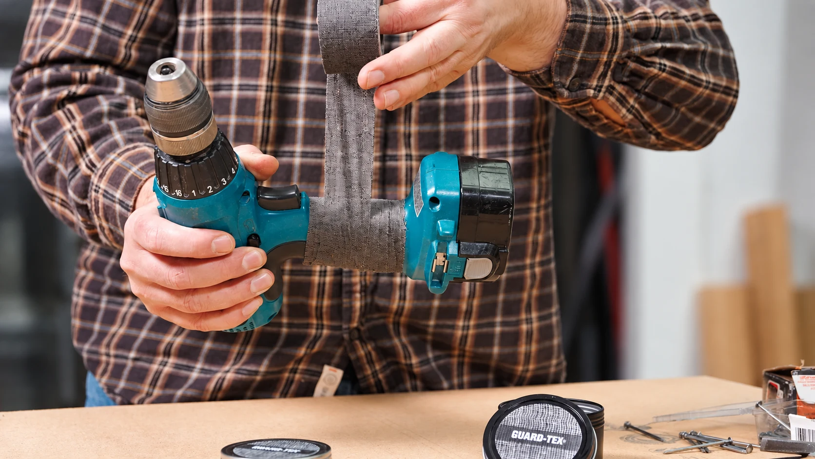 Charcoal Guard-Tex cotton tape being wrapped around a drill handle